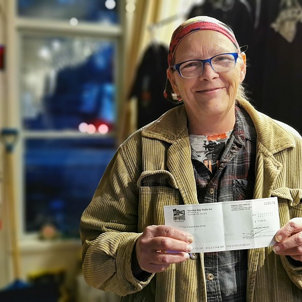 Winner collects $1000 bingo cheque!